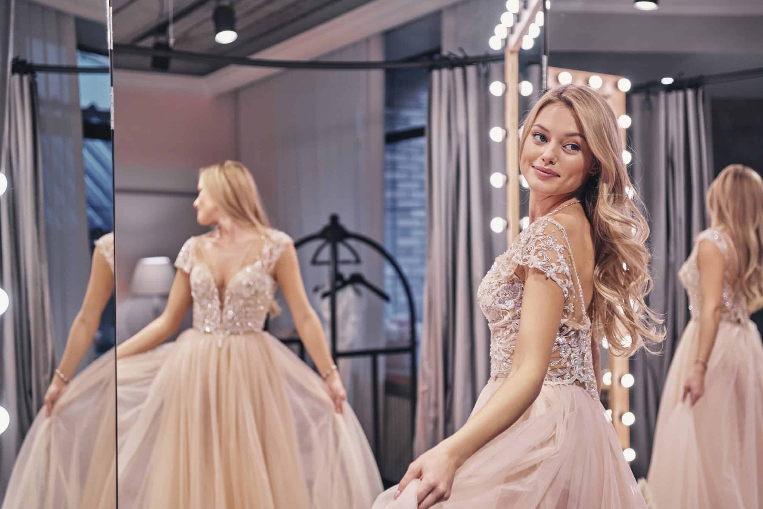Happy bride. Beautiful young woman wearing wedding dress and smiling while standing in front of the mirror in bridal shop Bridal Shop Darlington, County Durham 5